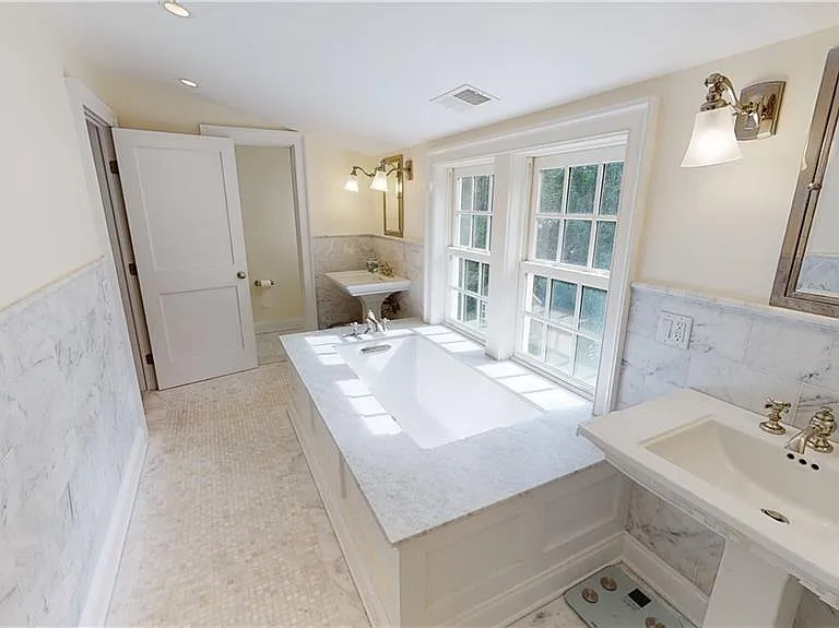 Beautiful primary suite bath with toilet room, shower room, and deep soaking tub - all with Waterworks high-end finishings