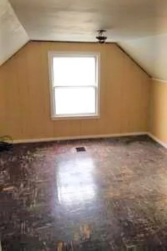 The upper bedroom as shown without furnishings, but the next show it with previous tenant's furnishings.