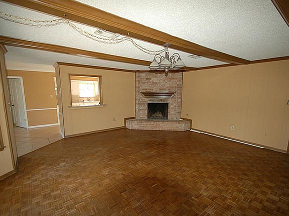 THE DEN ALSO HAS A CORNER FIREPLACE