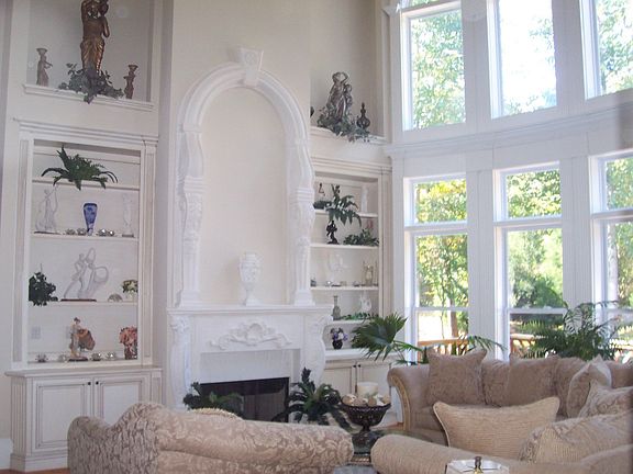 Custom limestone firelace flanked by bookshelves