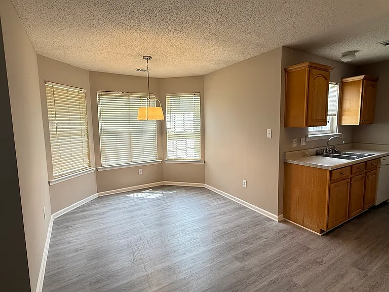 Sunny eat-in dining nook highlighted by a beautiful bay window and brand-new flooring throughout.