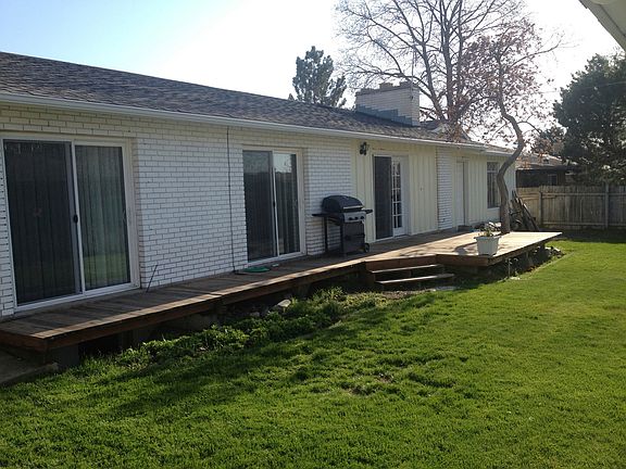 back deck and fenced in yard with shed