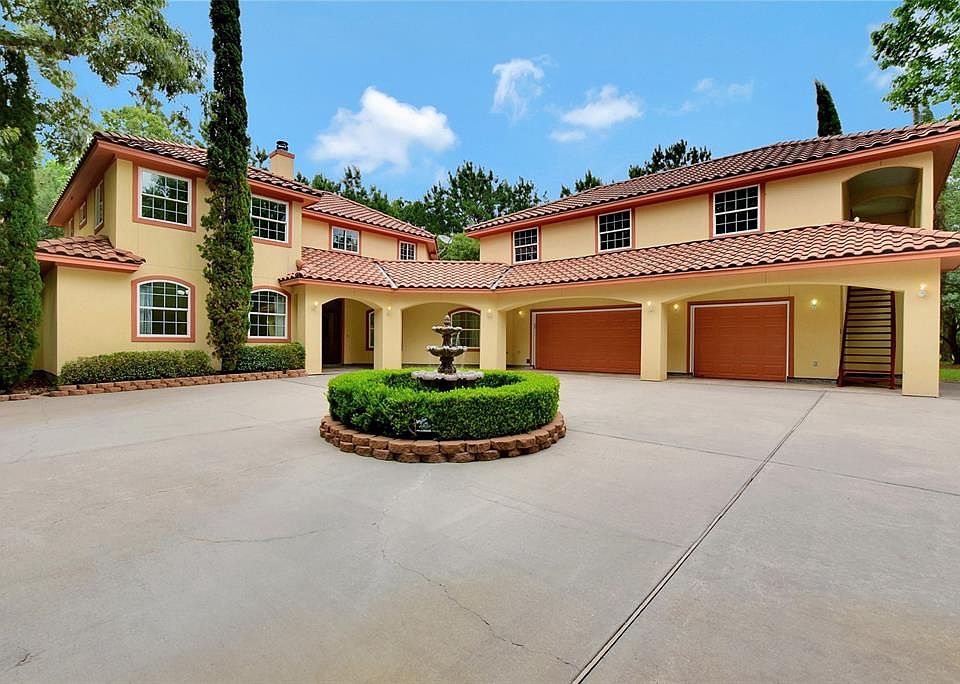 This beautiful daytime view of the cascading water fountain at the front of the home greets you with the soothing sounds of the trickling water
