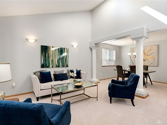 Open floor plan with vaulted ceilings offering architectural interest.