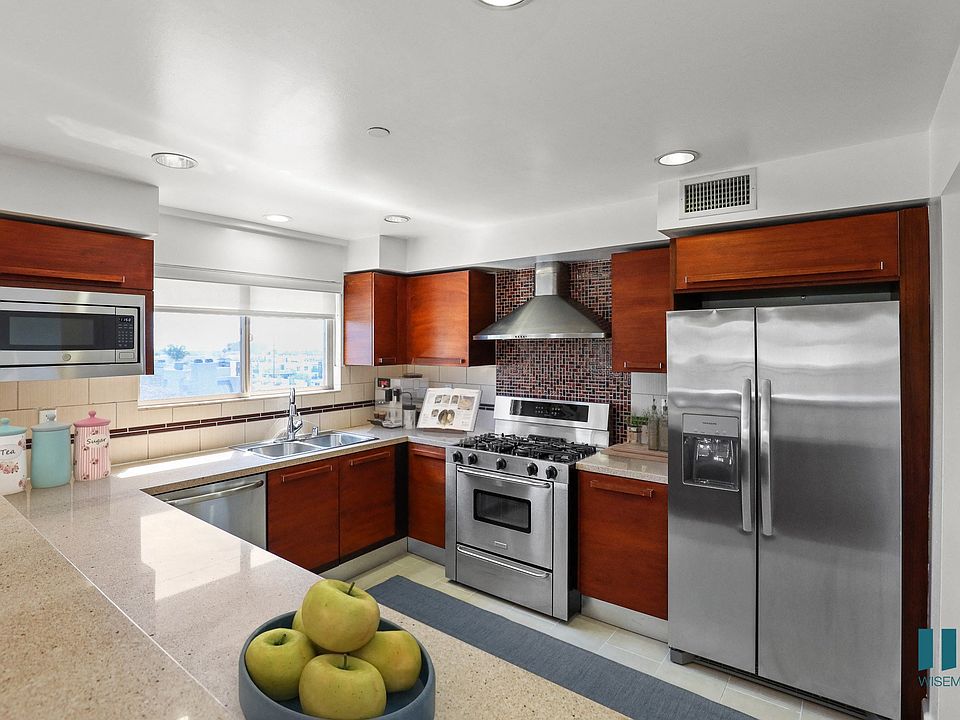 Large-Size Kitchen with Stainless-Steel Refrigerator, Stove, Microwave Oven, and Dishwasher