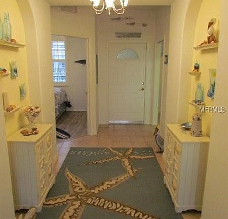 Foyer - note the arched niches and the tray ceiling with the chandelier.
