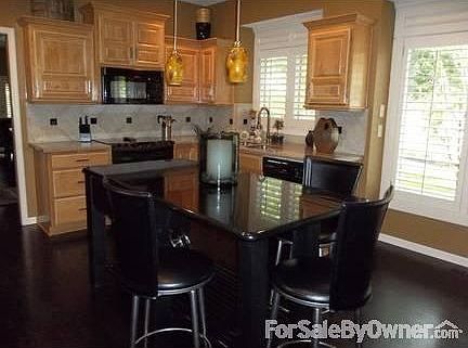Kitchen Island
						:
						Black granite island w/electricity, storage and seating. Pendant and can lights.