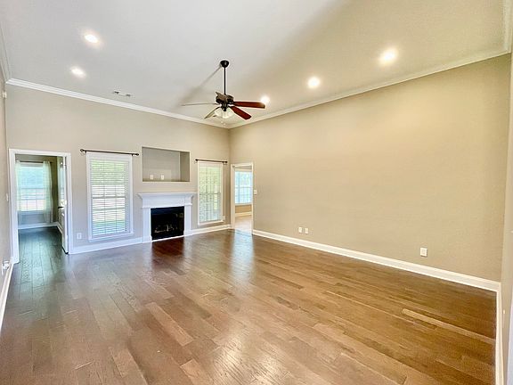 Large living room with tall, 12 ft ceilings and recessed LED lighting.