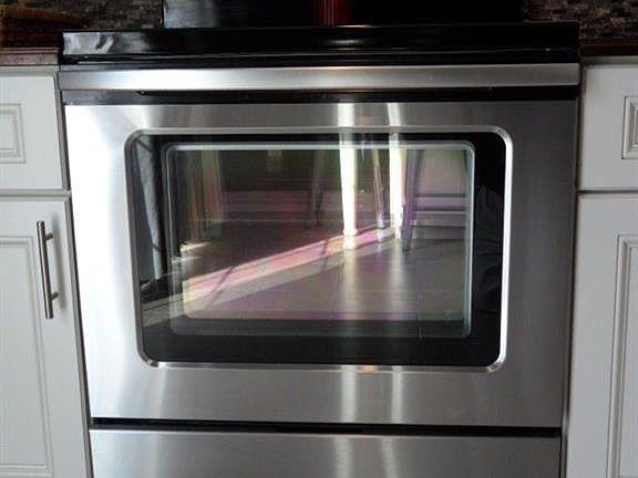 Stainless smooth top range with custom stone backsplash!