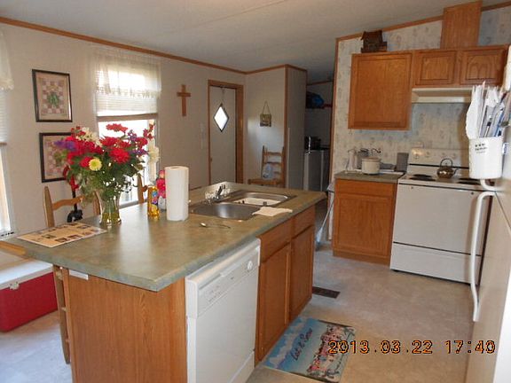 Kitchen has nice oak cabinets and white appliances
