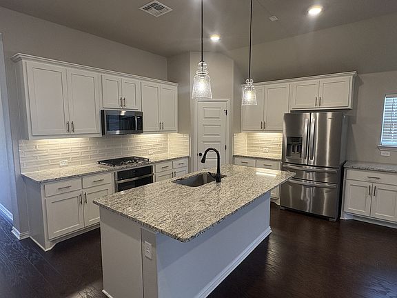 Kitchen with gas stove, fridge included.