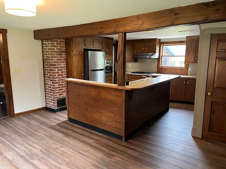 Eat in kitchen with large dining area and island with bar.