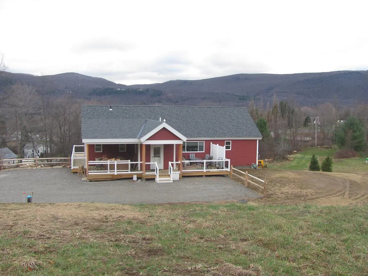 The view of the rear of the home with covered and open porch - 153 Deer Meadow Rd