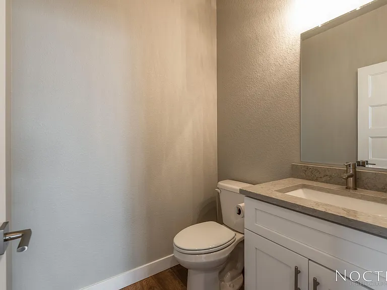Off the entry way is 1/2 bath. (Photo of another unit with similar finishes and quality.)