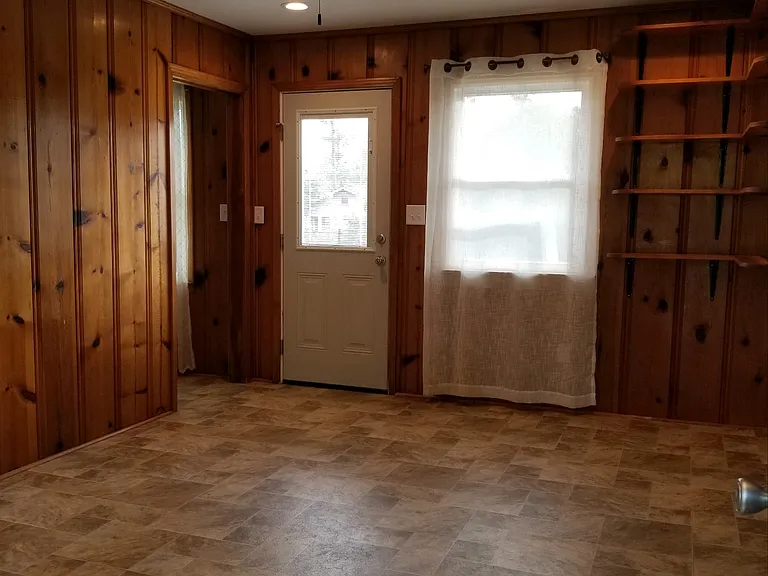 Florida room, to the right is the carport and the open doorway on the left leads to the kitchen, the door straight in front leads to the fenced in back yard