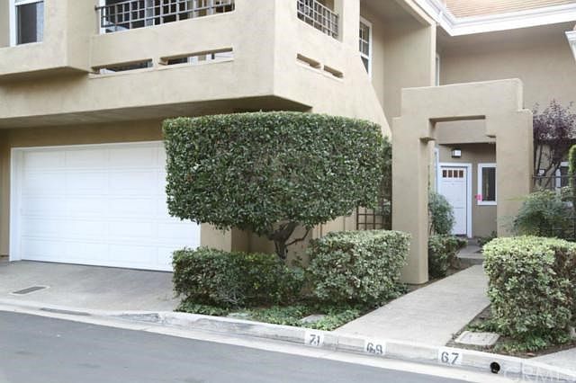 Front of Condo showing garage door and entry door.