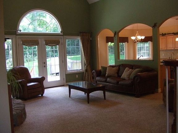 Great Room has vaulted ceiling, custom stone fireplace, wall of windows.