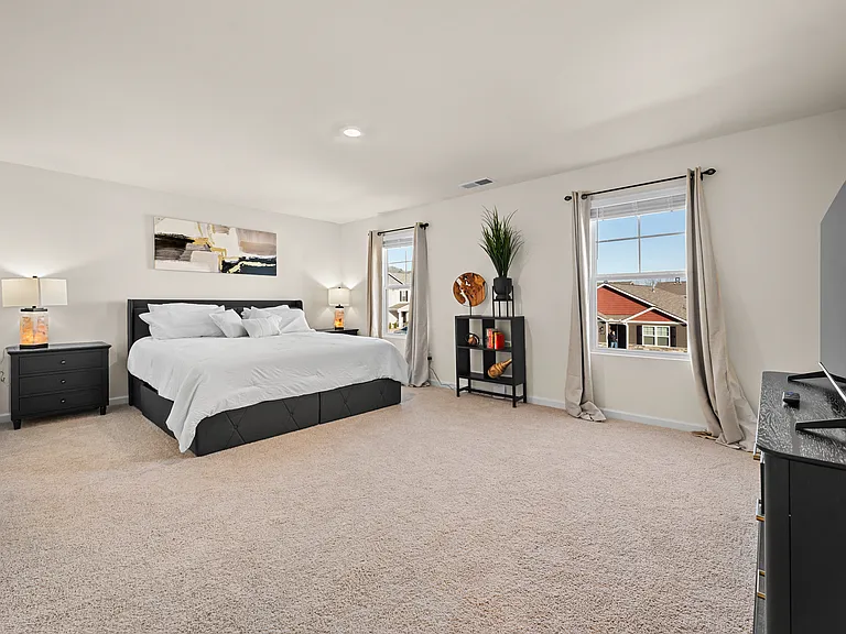 Spacious master bedroom with King sized bed, 50' TV and private bathroom with walk in closet