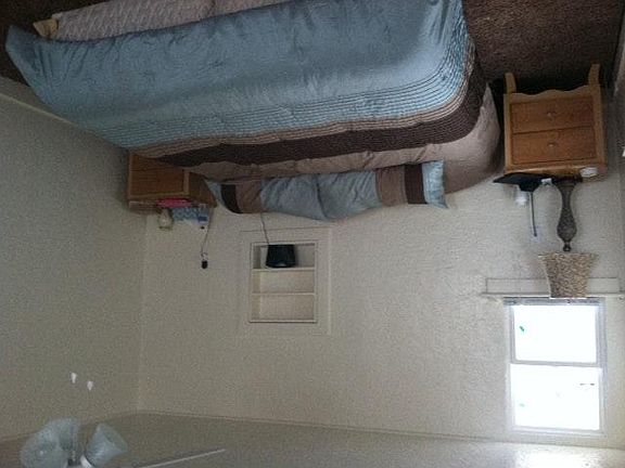 large master bedroom including ceiling fan.