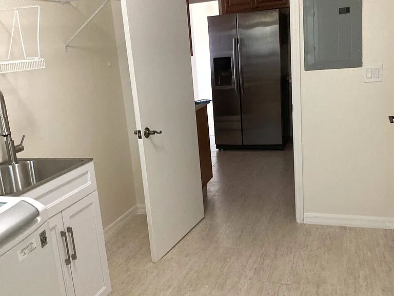 Laundry room with Washer, Dryer, stainless utility sink and shelving