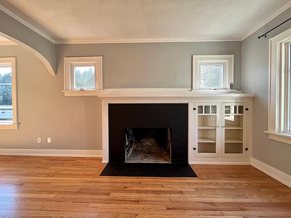 Fireplace and built-in bookshelves. (Fireplace is not operable.) Windows above fireplace were replaced in 2021 and are operable.