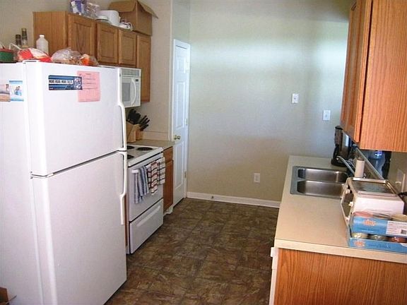Well appointed kitchen with white appliances