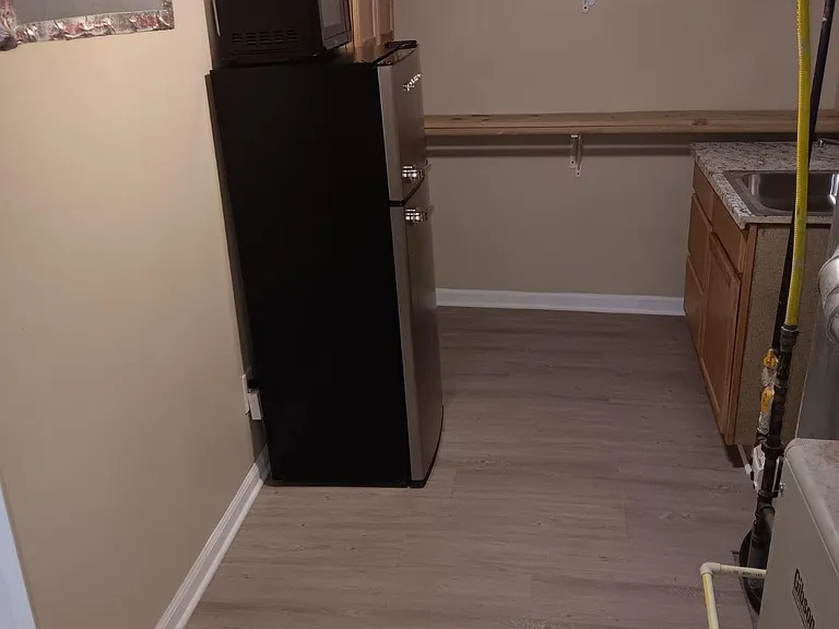 Walk in closet and mini kitchen in basement bedroom