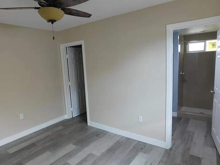 Walk-in closet and a huge bathroom with heating fan
