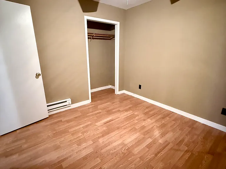 2nd bedroom with closet for hanging items and shelf