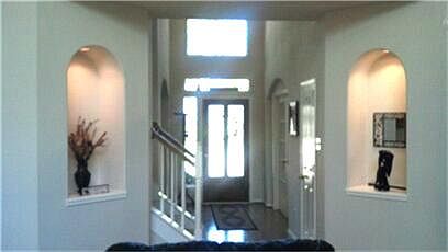 Large foyer has lots of natural lighting  and  lots of character .