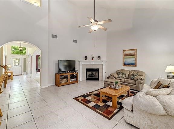 Open concept floor plan with high ceilings is bright and cheery. The fireplace is the prefect place to curl up with a good book, a loved one or both.
