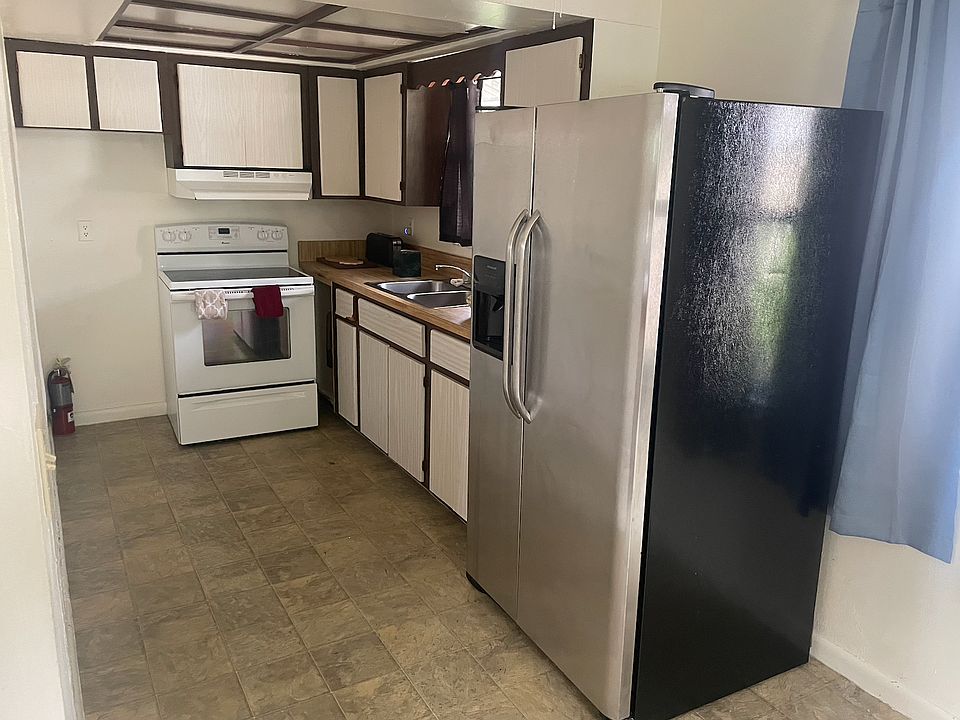 Kitchen includes glass top stove and very large refrigerator