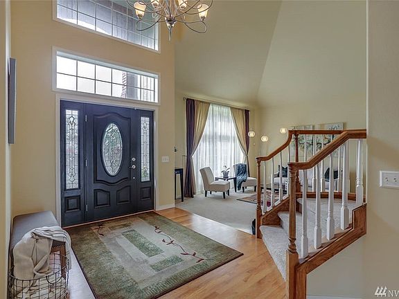 This two story entry is bright and airy with vaulted ceilings