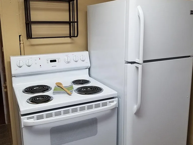 Kitchen features new paint and vinyl flooring. New stove/ra