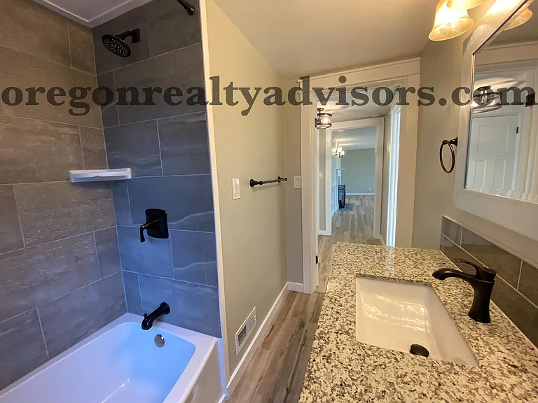 Upstairs bathroom with tub looking into Living Room