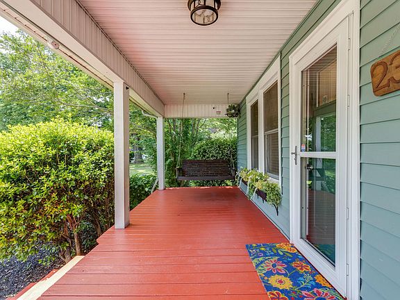 Large covered porch with charming window boxes. String lights have been added since photo.