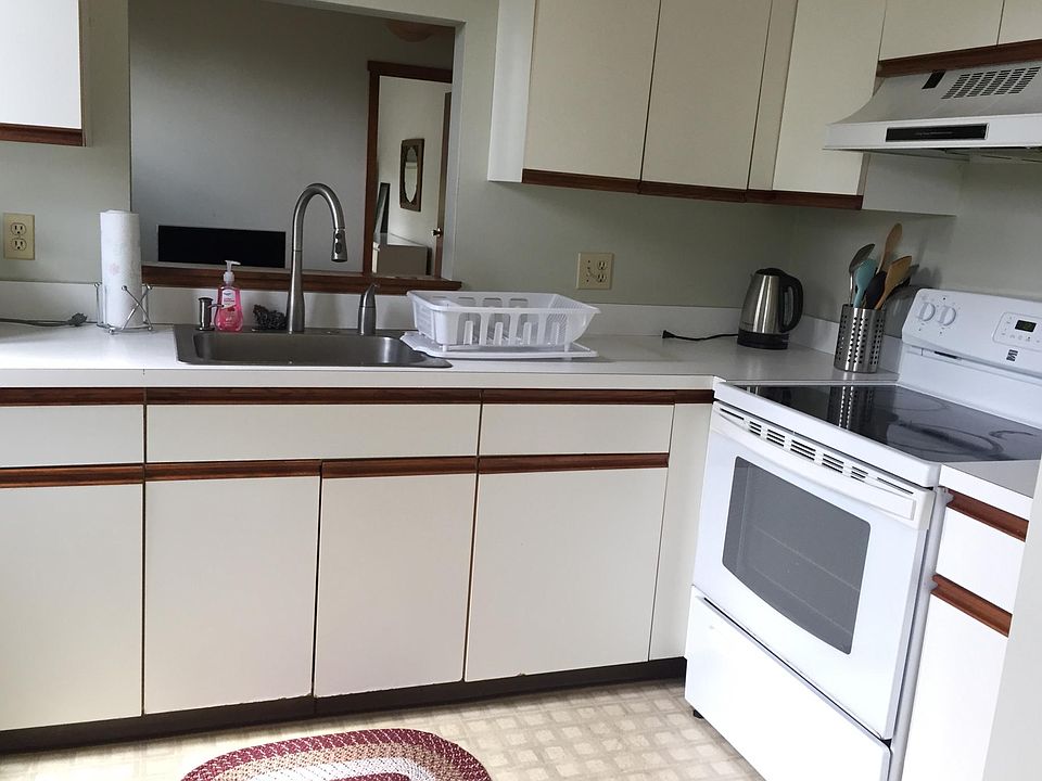Kitchen, has an interior window opening to Living Room.
