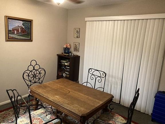 Dining room, blinds lead to balcony.