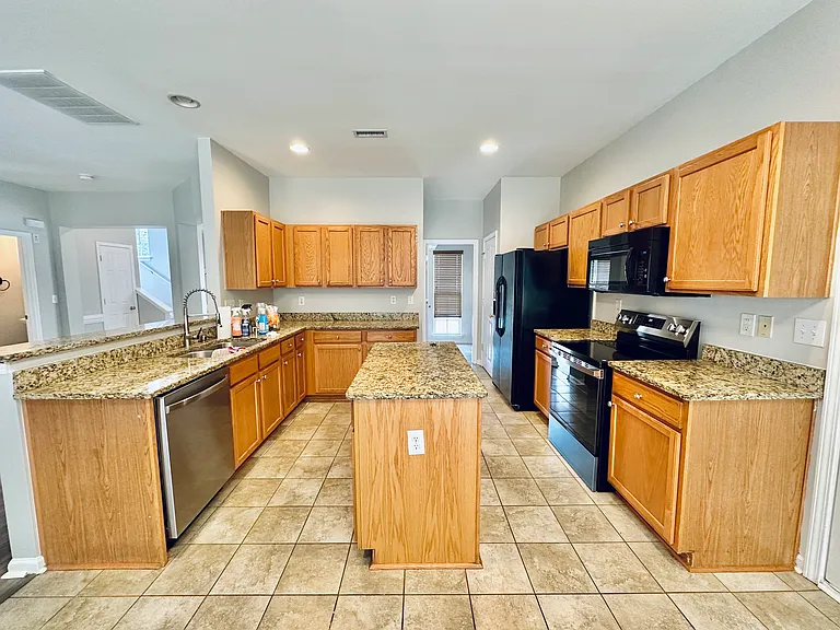 Kitchen with ample cabinets and granite counters.