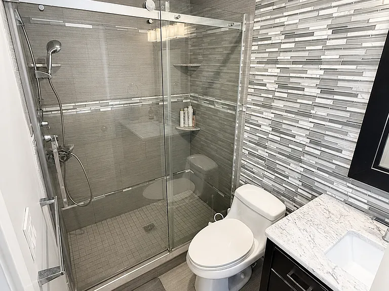 Updated bathroom with glass-enclosed shower