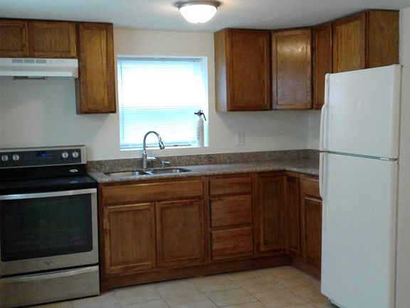 Granite counter top. Glass top electric range. No dishwasher and no garbage disposal. Fridge has been upgraded to stainless steel and has an ice-maker.