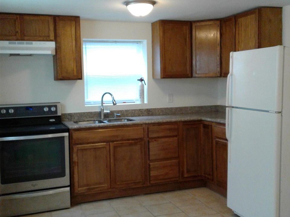 Granite counter top. Glass top electric range. No dishwasher and no garbage disposal. Fridge has been upgraded to stainless steel and has an ice-maker.