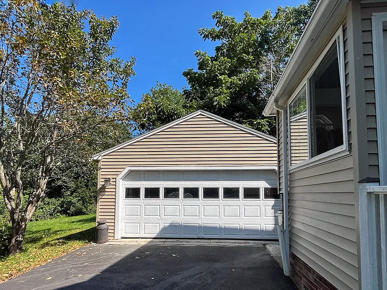 Two car garage with automatic garage door opener and built in tool bench.