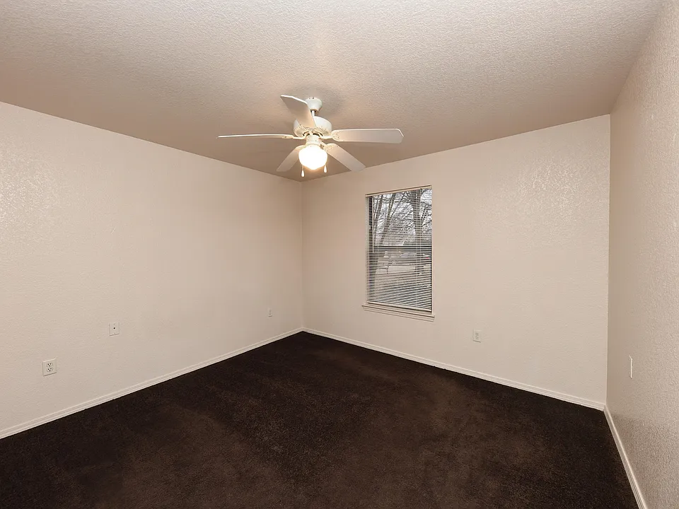 Cozy bedroom with carpet & ceiling fan