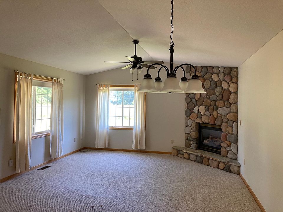 Dining room/great room with new light fixtures and new paint. Neutral colors