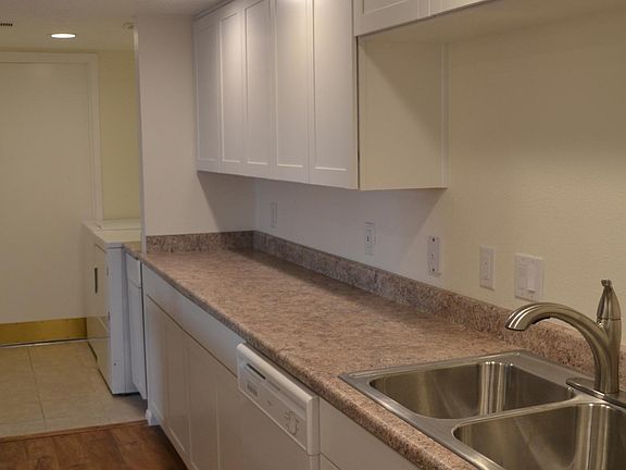 A door to the garage opens through the kitchen and laundry a