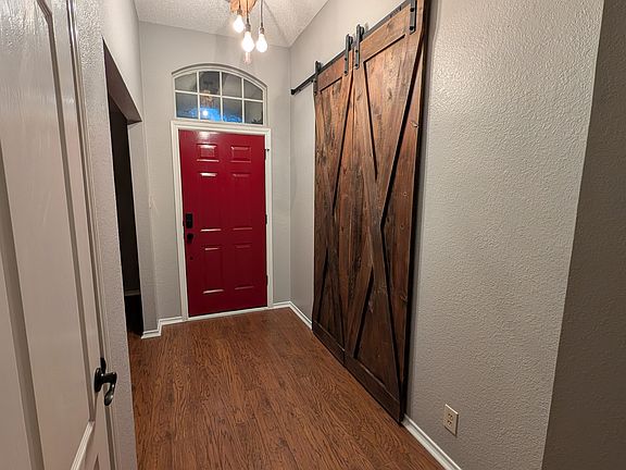 Entryway with sliding barn-style doors to the office/4th bedroom