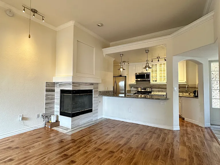 View of the kitchen and fireplace from the balcony.