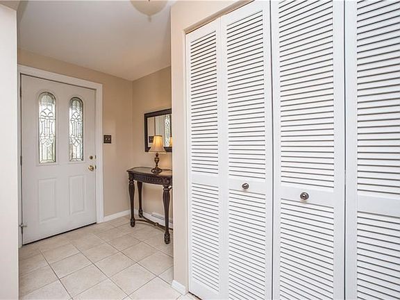 Entry way with tile flooring has plenty of space for coats and storage.