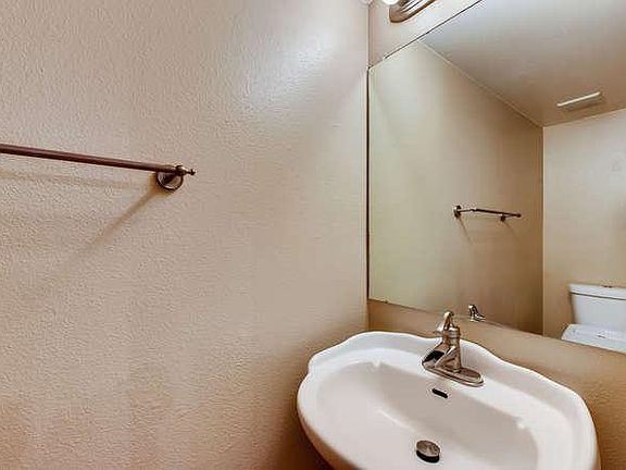 1/2 bath has pedestal sink and Japanese style bidet toilet